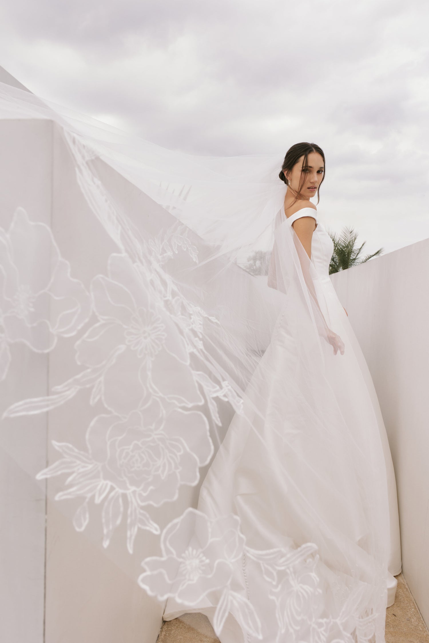 Model wearing a modern 3D floral lace wedding gown from Briderful's newest bridal collection.